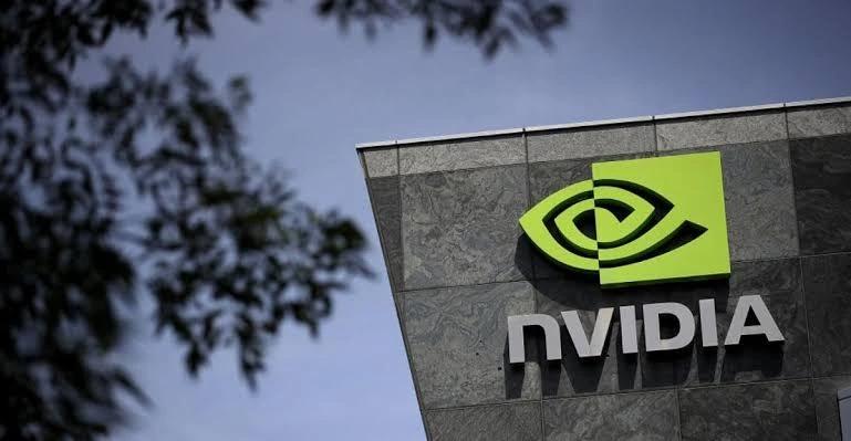 لوگوی NVIDIA روی نمای ساختمان این شرکت، با آسمان و شاخه‌های درخت در پس‌زمینه.